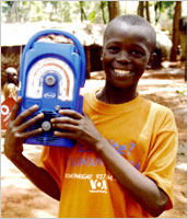 Child holding Freeplay solar shortwave radio