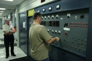 Technician presetting the tuning controls of a GE 250 kW transmitter for the next operating frequency (Click to enlarge)