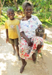 Post-earthquake, ETOW radios continue to be a vital link for those in need in Haiti. Here, Erlande, who suffered a stroke in her early 30s and can barely walk, listens to one of our self-powered Etón radios, given to her by the Haitian Health Foundation.