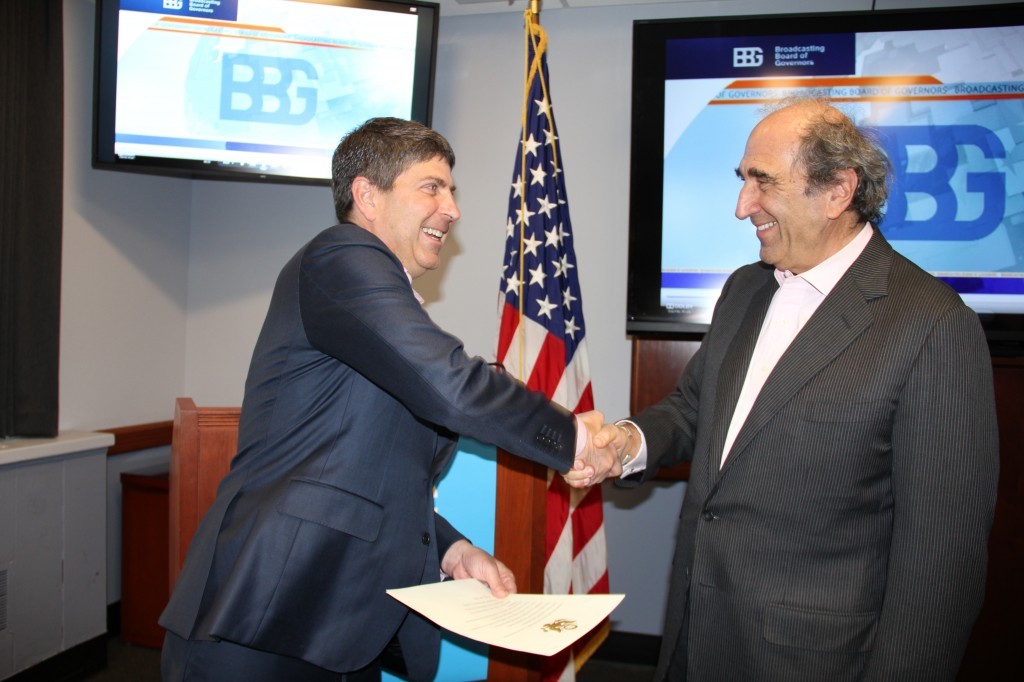 Jeff Shell, Chairman of the Broadcasting Board of Governors, congratulates Andy Lack after swearing him in as the first ever CEO of U.S. international media. (Image Source: BBG Press Release)